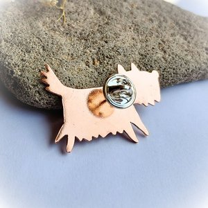 Rear view of the handcrafted copper scruffy terrier dog brooch showing the brooch pin fastened
