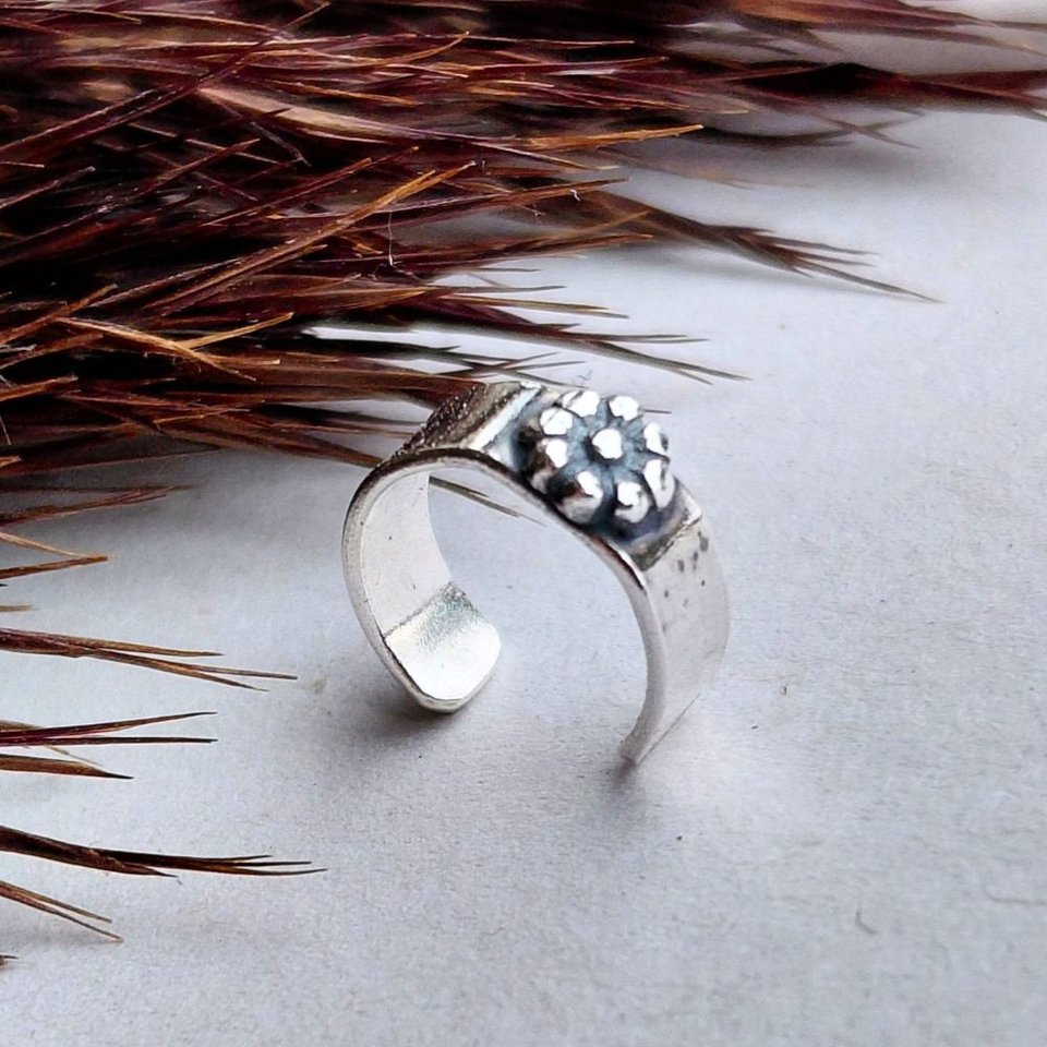 Handcrafted sterling silver helix cuff with a tiny fine silver daisy flower