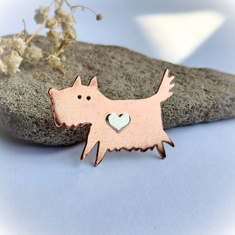 Alternative view of the handcrafted copper scruffy terrier dog brooch with a sterling silver heart