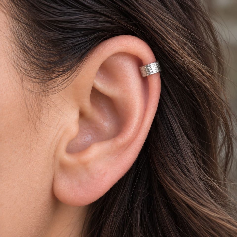 Hammered sterling silver ear cuff shown being worn on the helix of a woman's ear