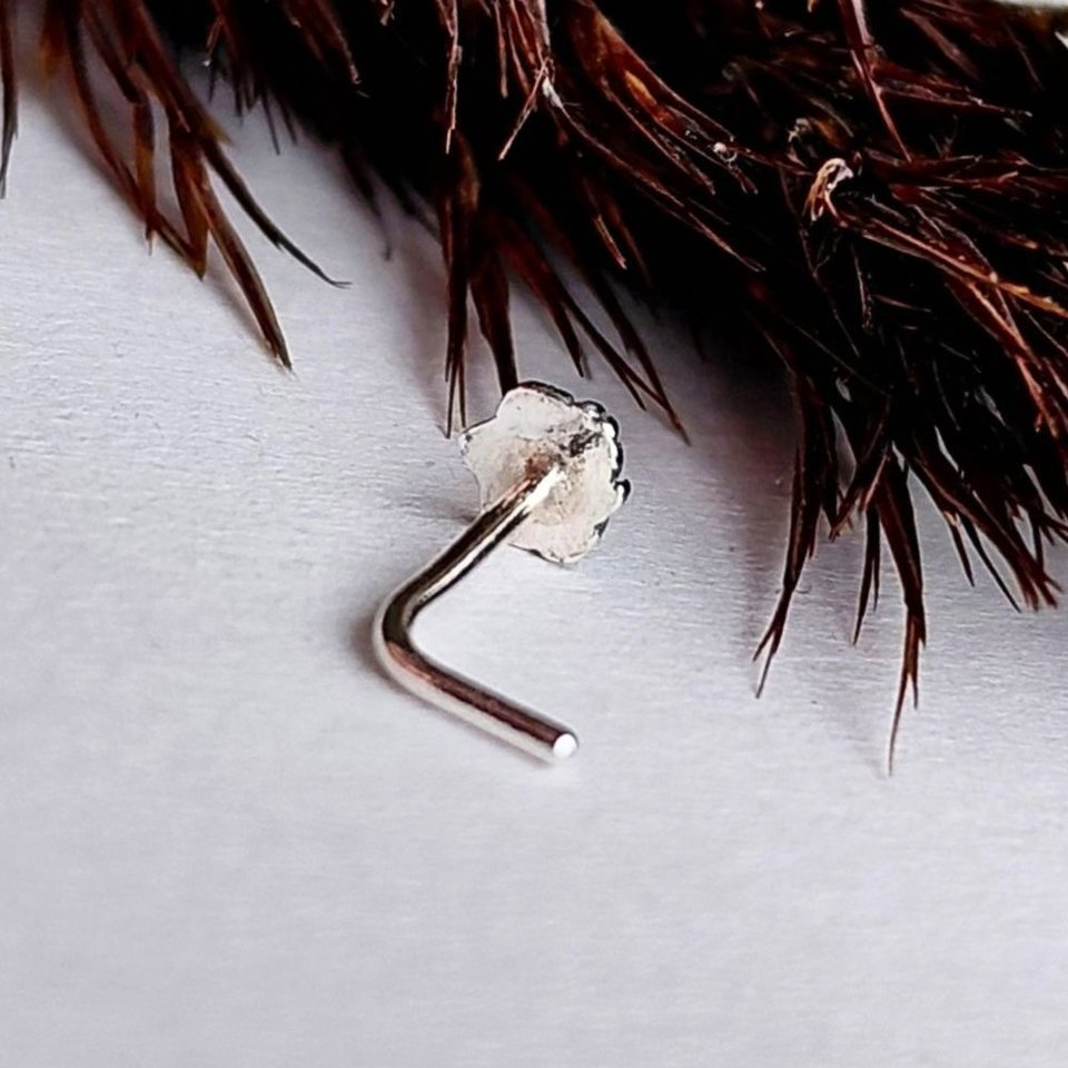 Sterling silver L-shaped nose stud with a fine silver maple leaf detail, shown from the back